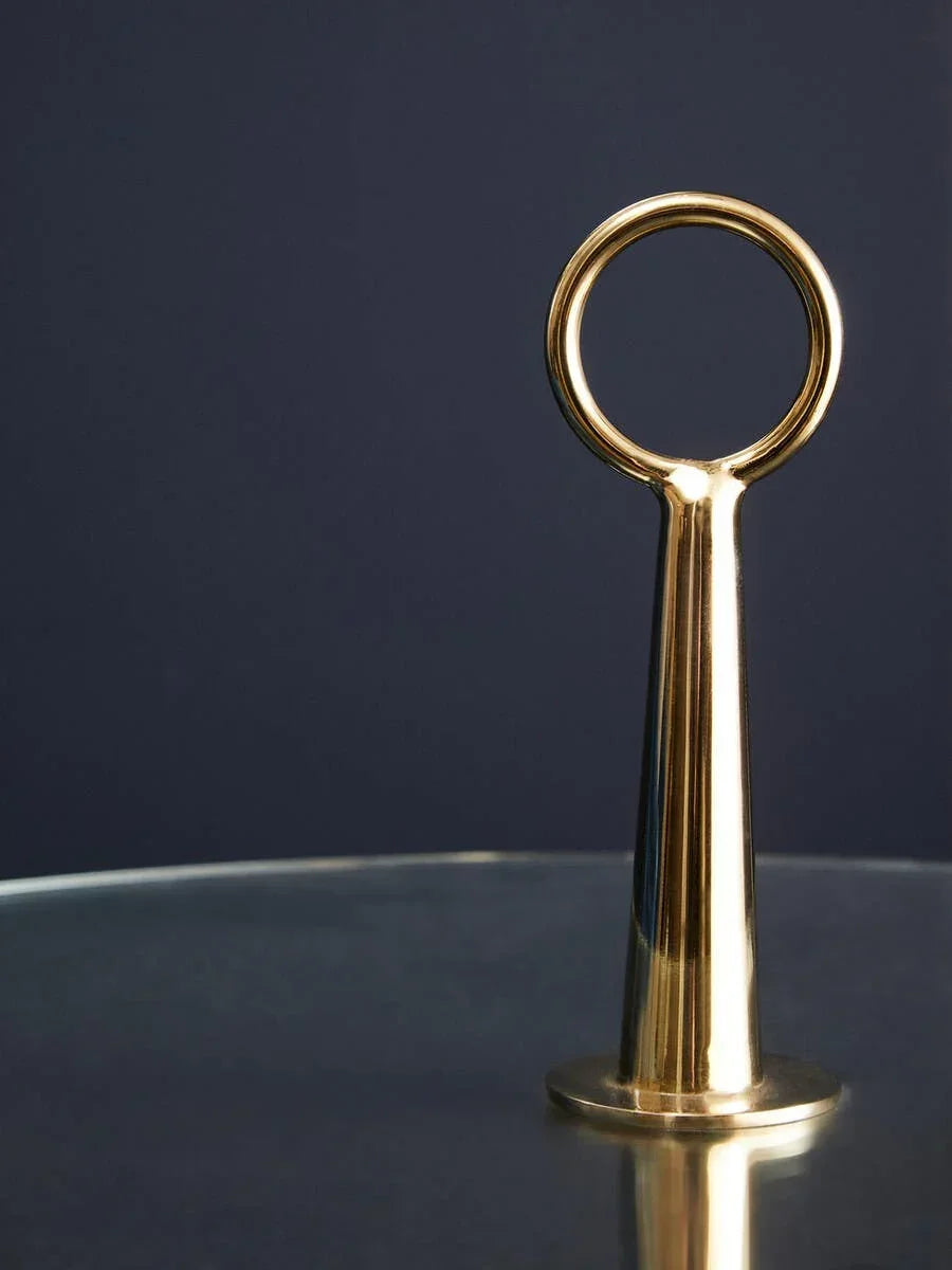 Brass handle on glass coffee table against dark background
