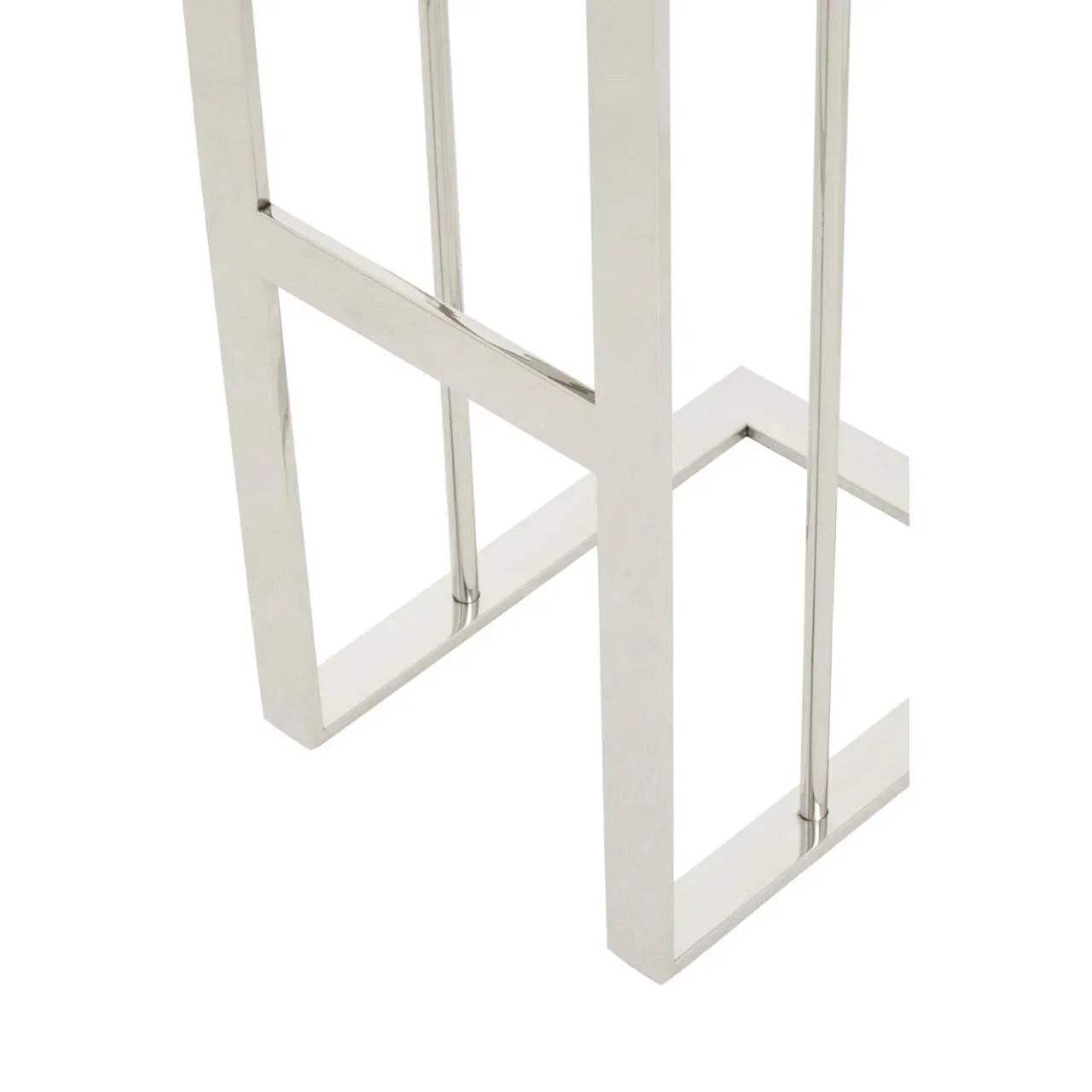 Close-up of polished chrome metal table leg with geometric frame design