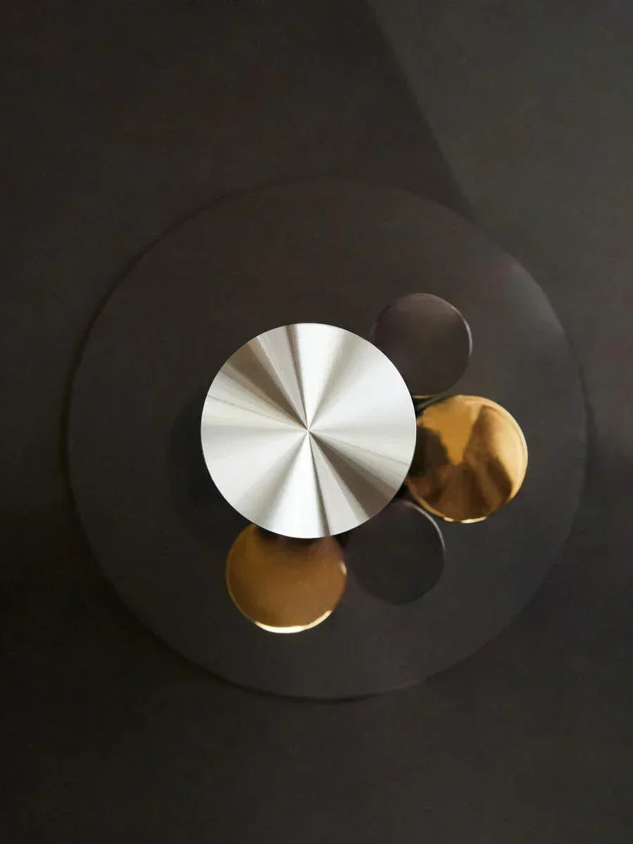 round metal coffee table with brushed silver and gold circular accents, top view