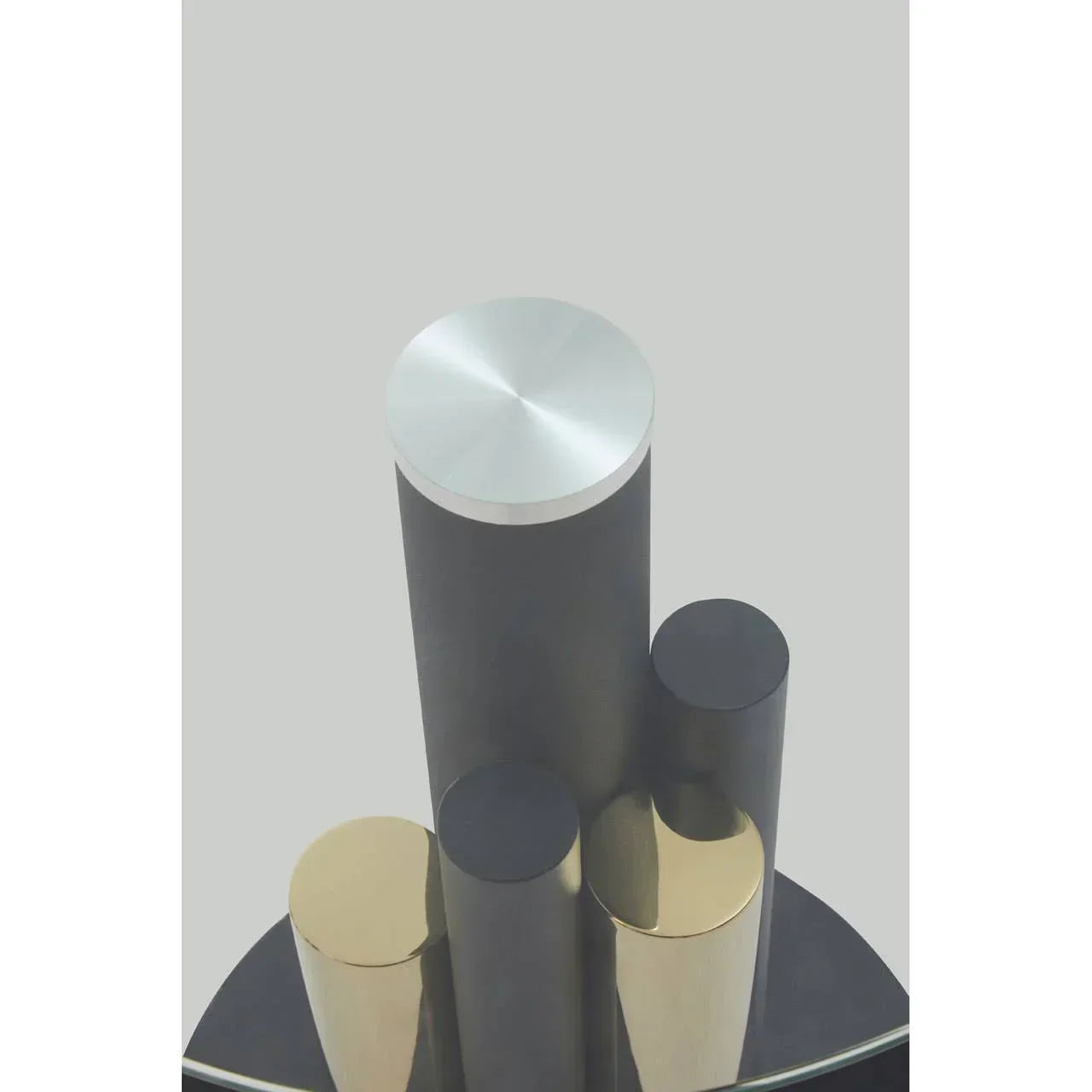 Modern coffee table metal cylindrical legs in gold and silver finish, close-up top view