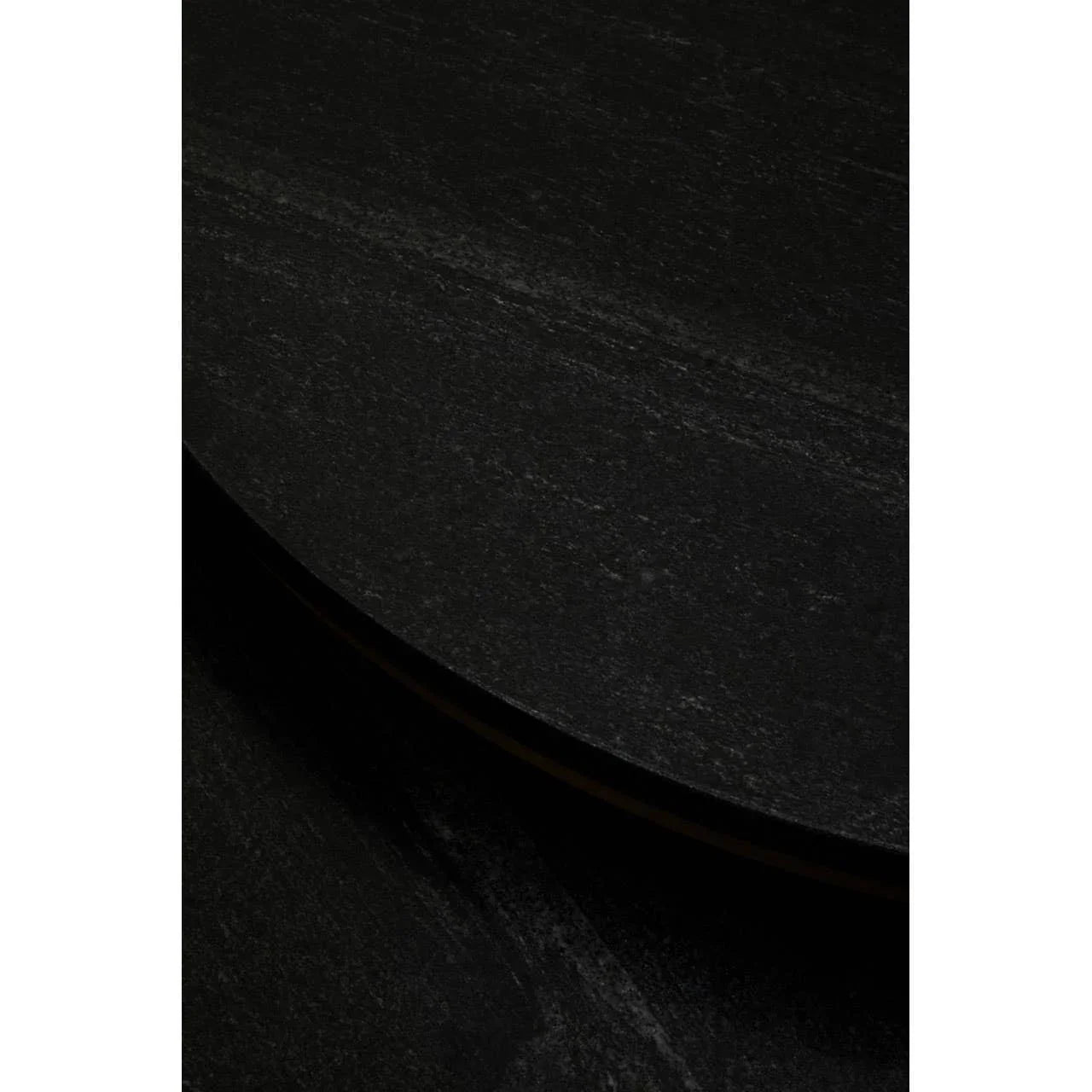 Close-up of black stone coffee table with textured round surface