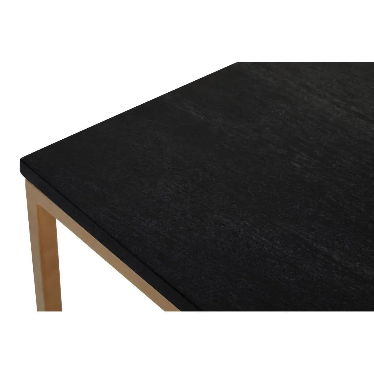 Close view of black dining table top with gold metal frame corner