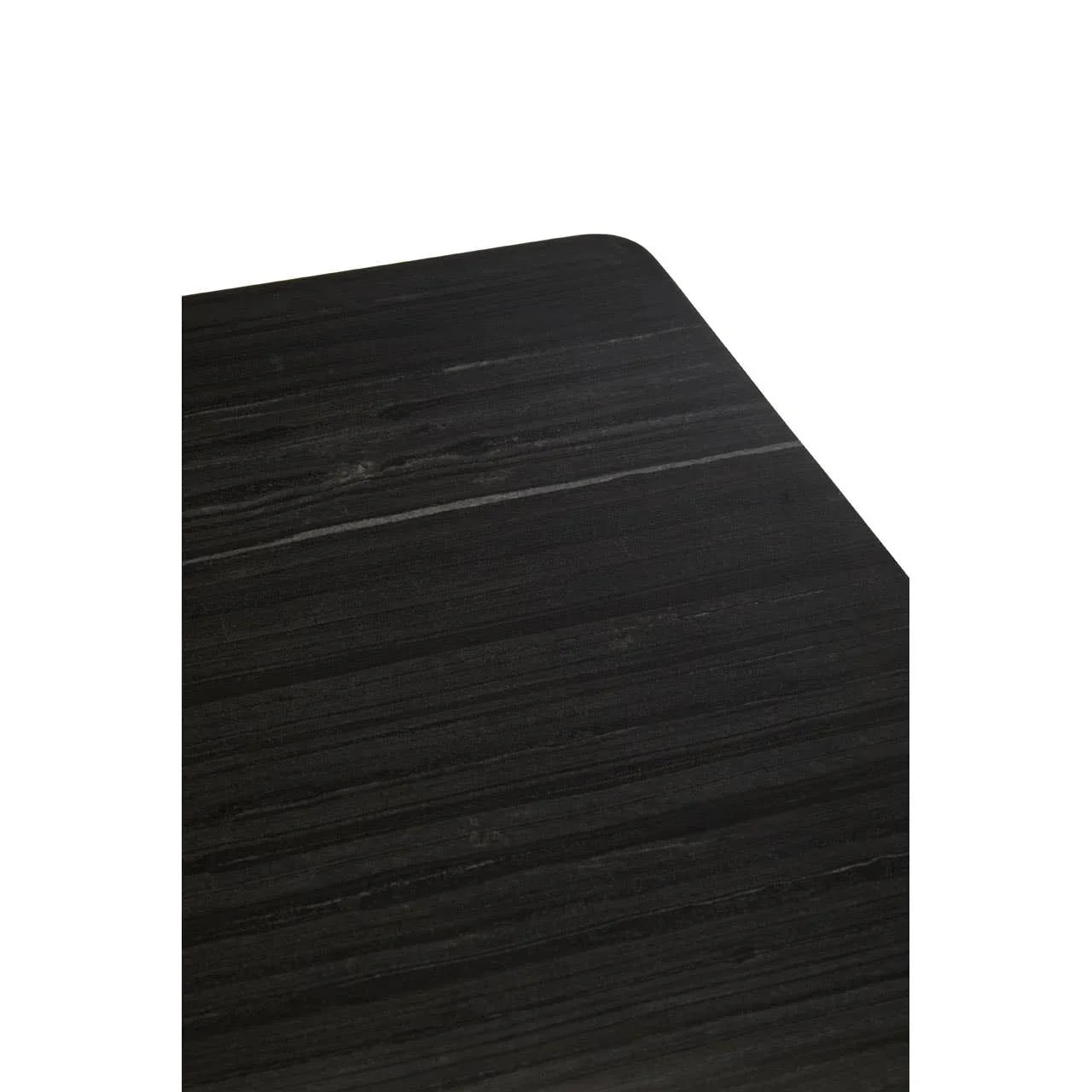 Black wood dining table corner with dark grain detail and rounded edge