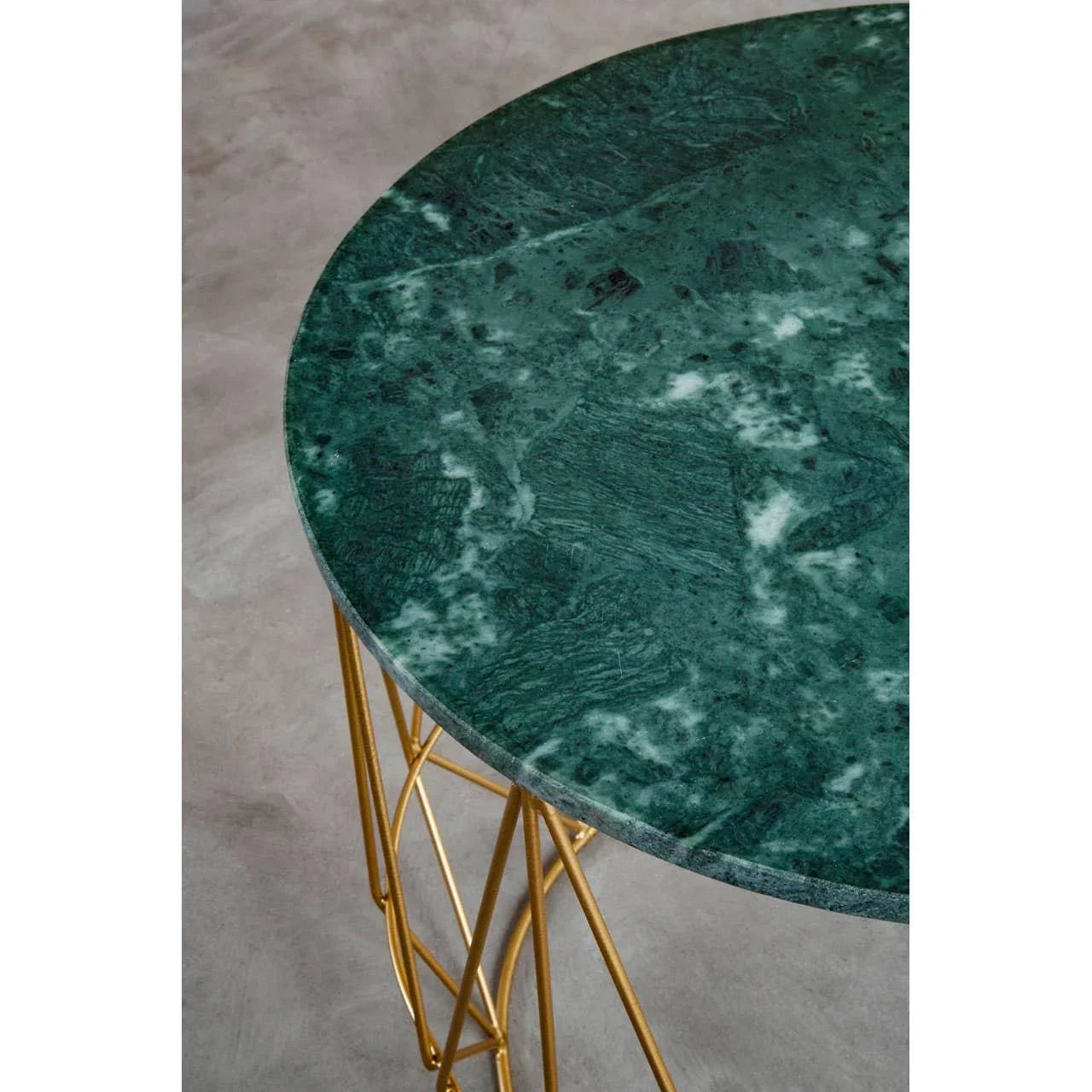 Round green marble table with gold metal legs, close-up of textured top and frame
