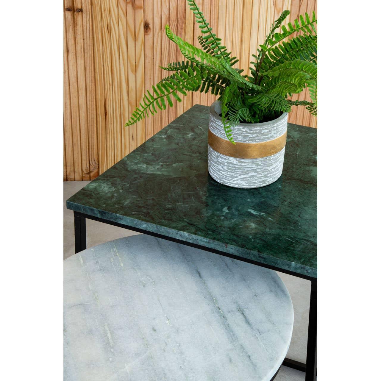 Square green marble side table with potted fern and circular grey shelf below