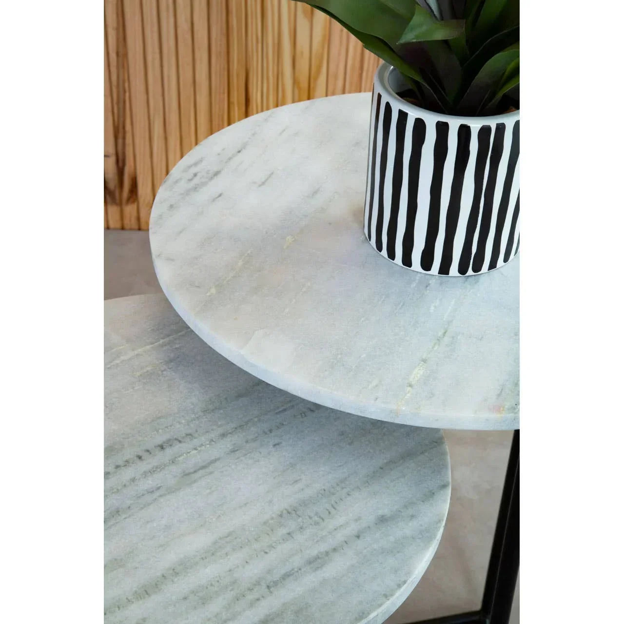 Round marble side tables with black metal frame and striped ceramic plant pot