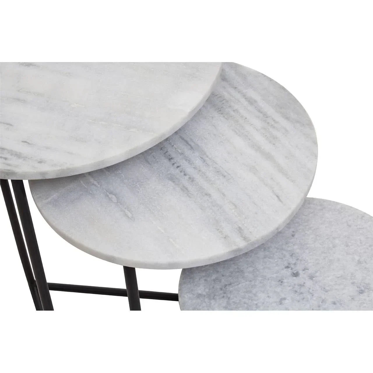 Close-up of round marble nesting tables with light grey tops and black metal legs