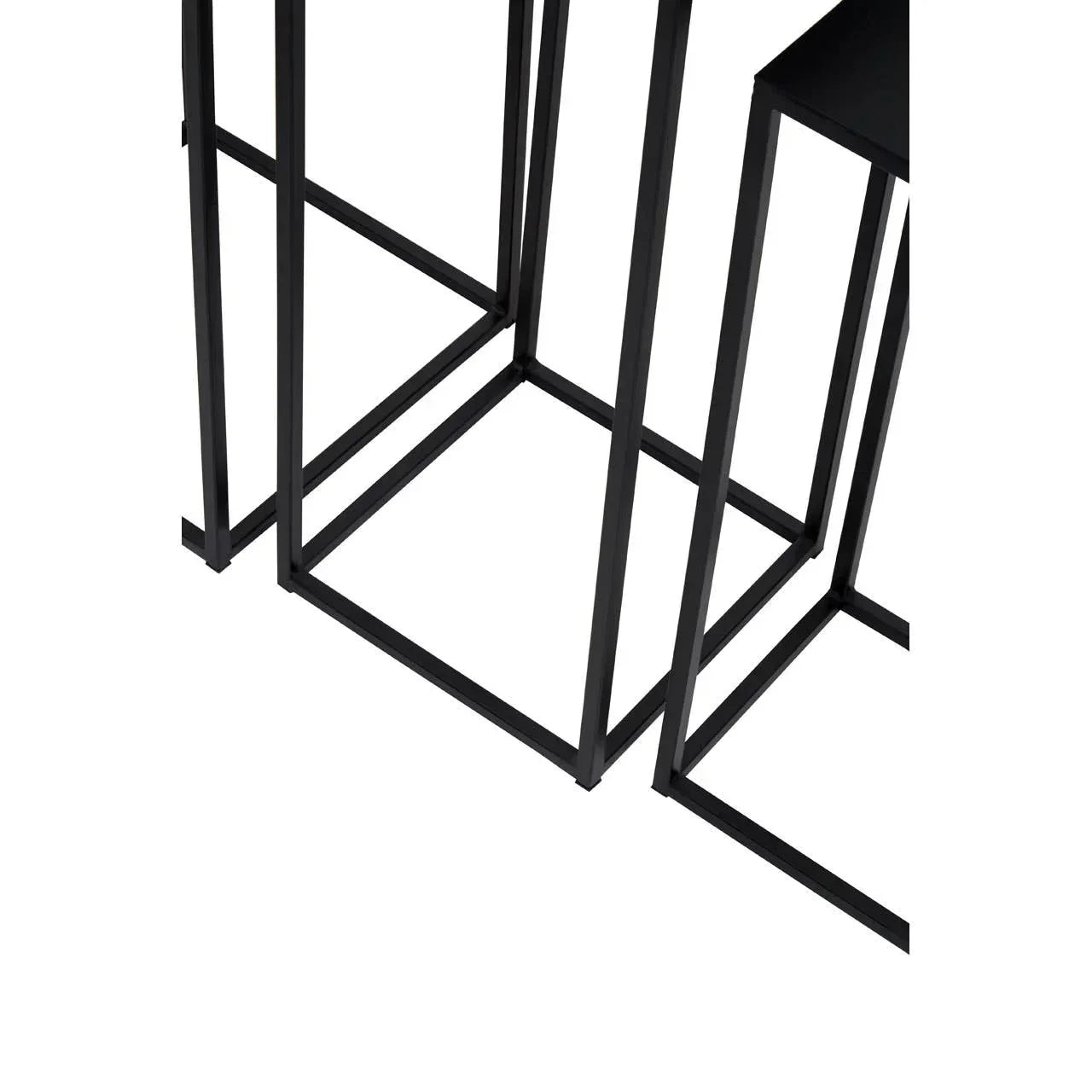 Black metal side table legs in geometric design, close-up view on white background