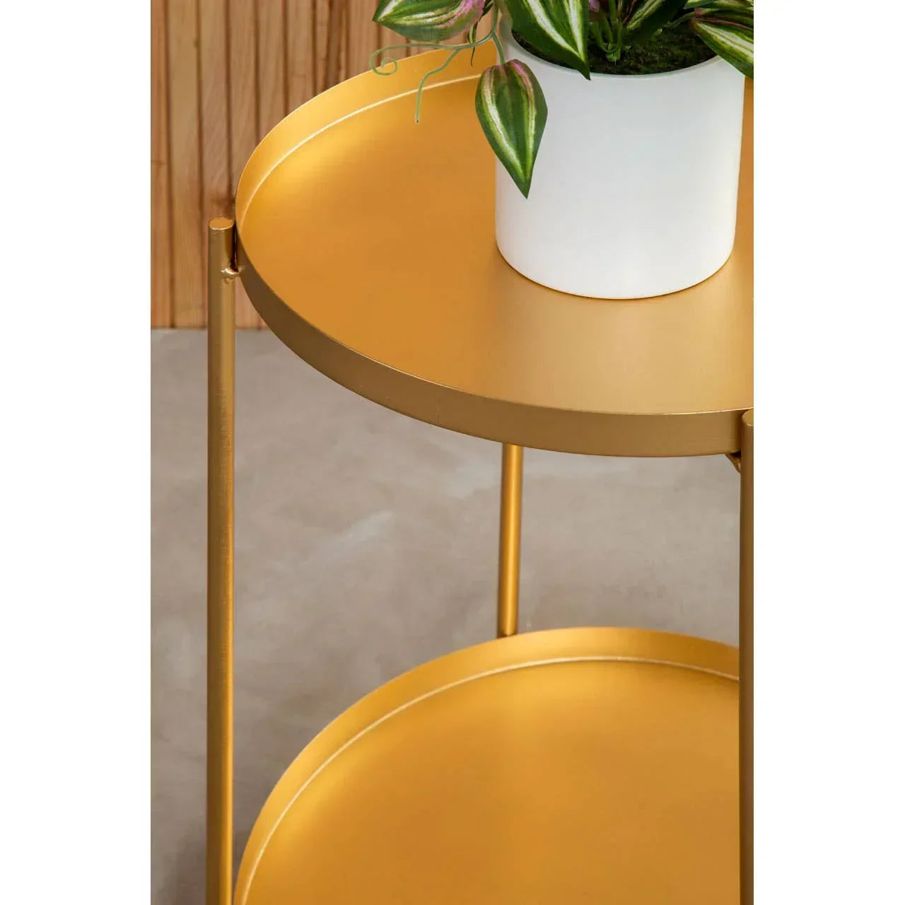 Gold metal side table with two tiers and a white planter on top