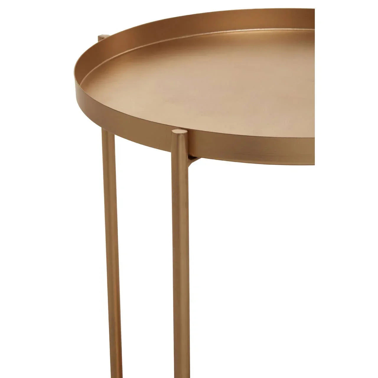 Round gold metal side table with raised edge and slim tripod legs, close detail view