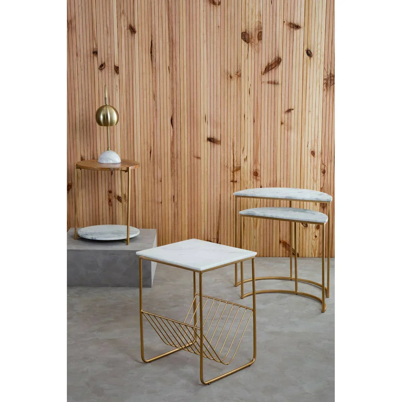 Modern marble top side tables with gold metal frames against wood panel wall
