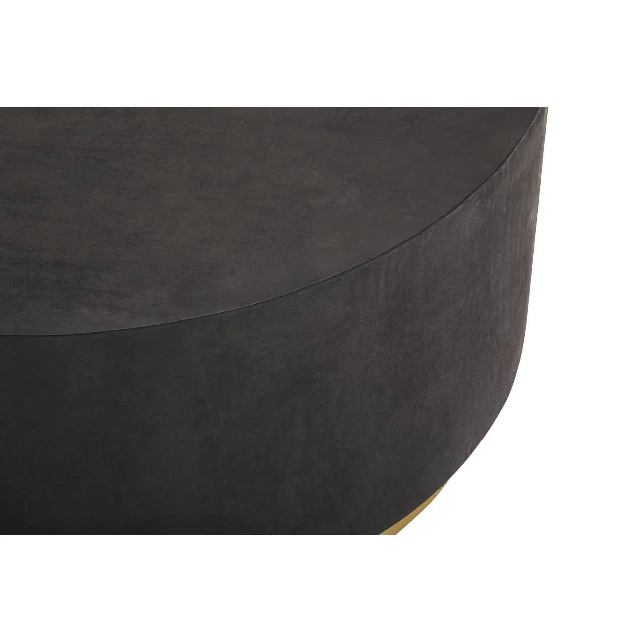 Round black coffee table with matte finish and curved edge, close-up of top surface