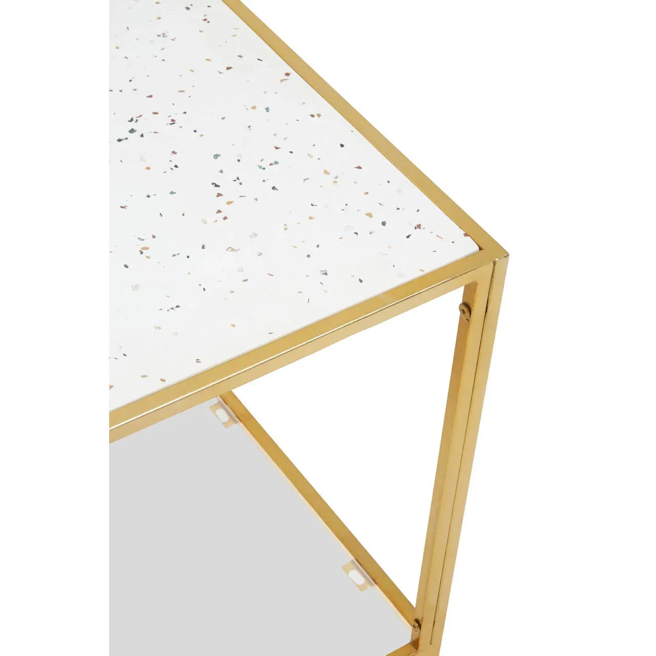 Terrazzo side table with gold metal frame and white speckled top, close-up corner view