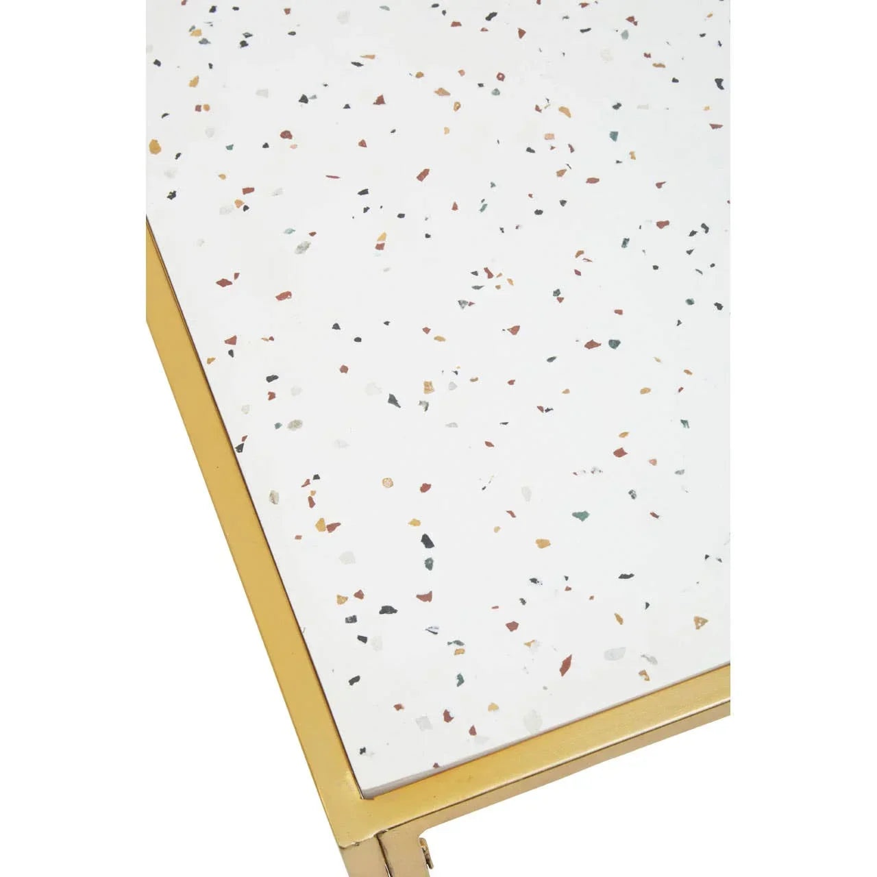 Terrazzo coffee table close-up with gold metal frame and white speckled top