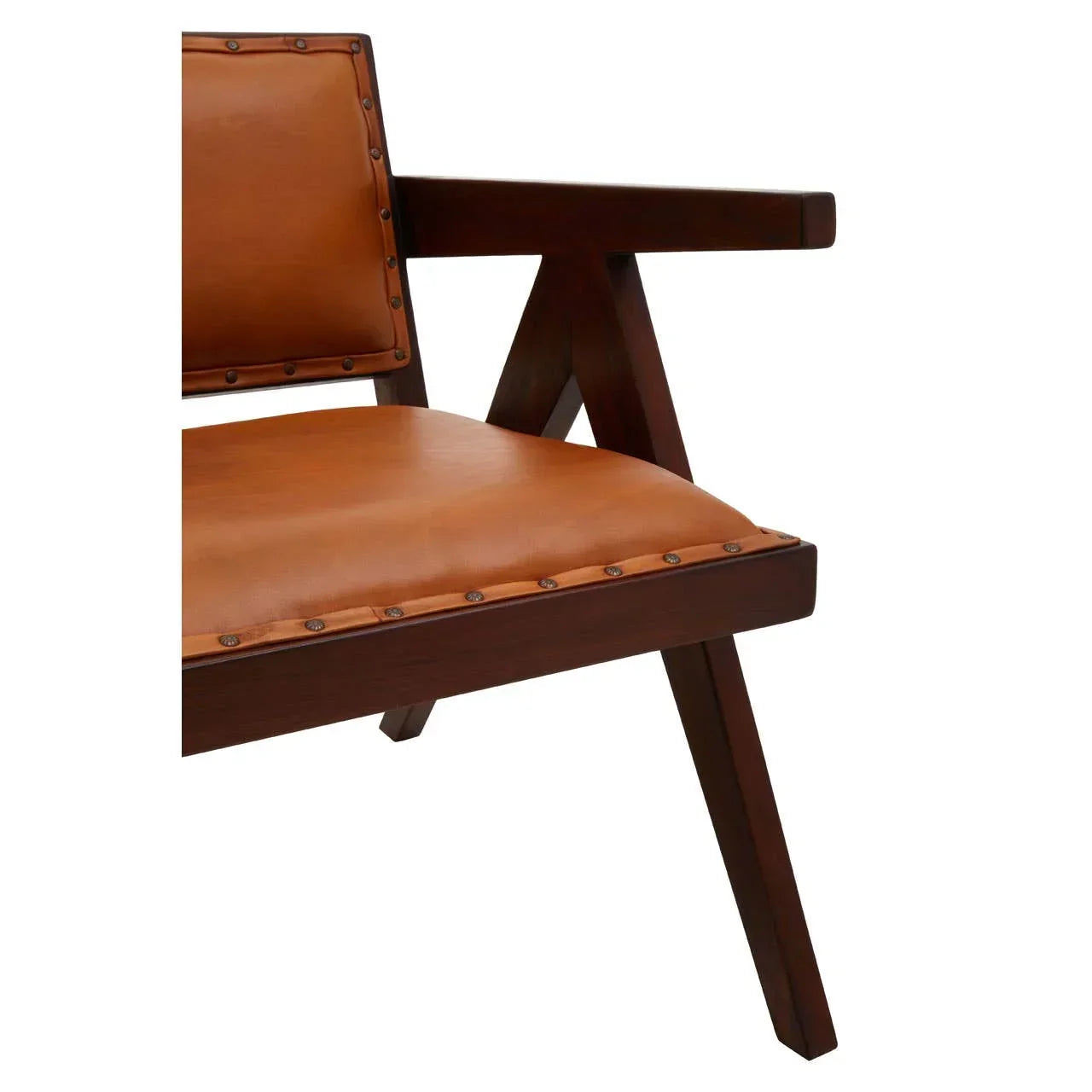 Close up of brown leather armchair with dark wood frame and metal stud detailing