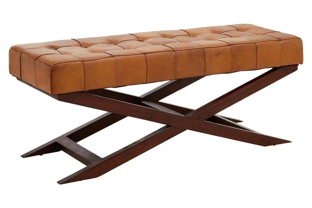 Tan leather bench with tufted seat and dark wood crossed legs