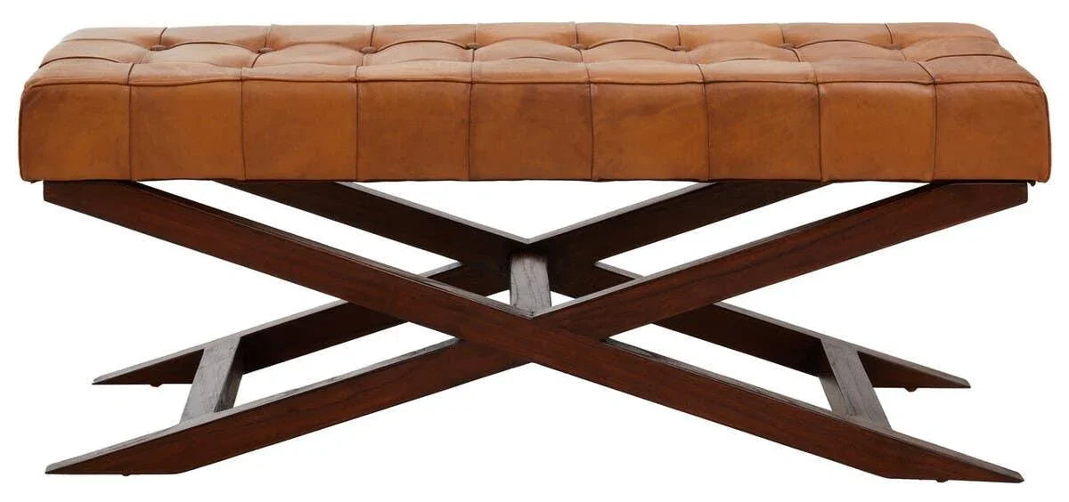 Tan leather bench with tufted seat and dark wooden crossed legs, side view