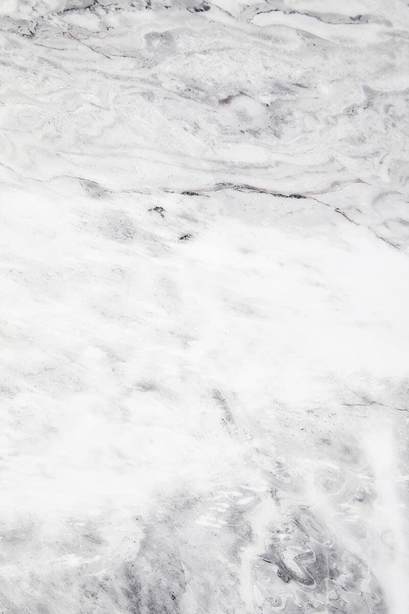 white marble tabletop with grey veining, close-up surface texture