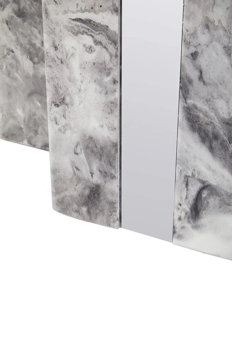 Closeup of marble dining table base with grey and white stone finish and chrome accent
