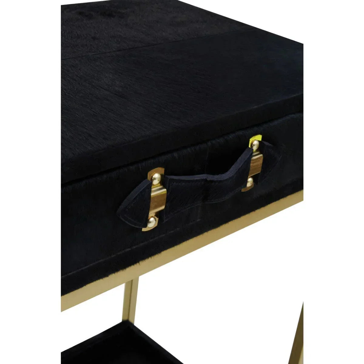 Closeup of black velvet console table with gold handle and brass accents