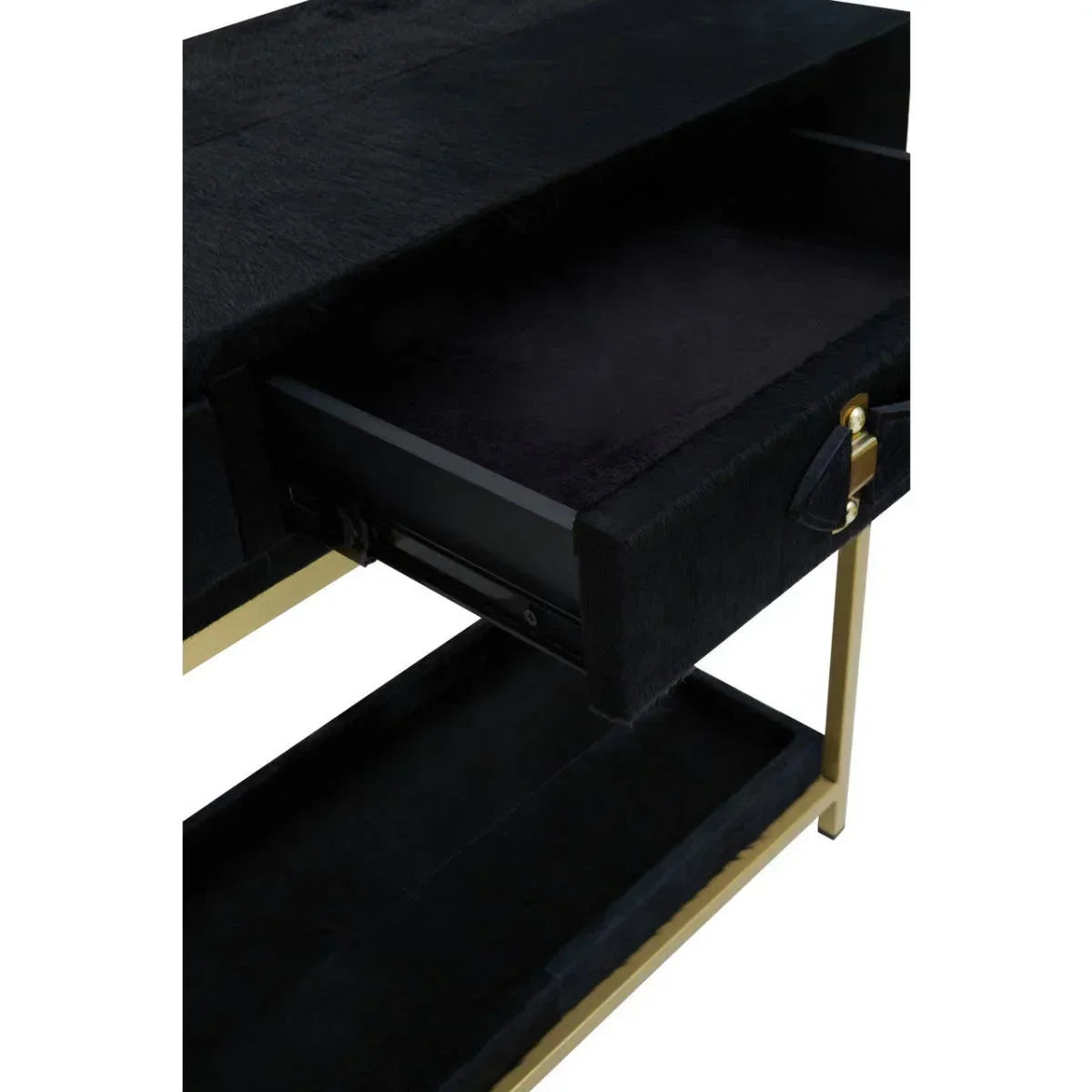Black console table with open drawer and gold metal legs, close-up view