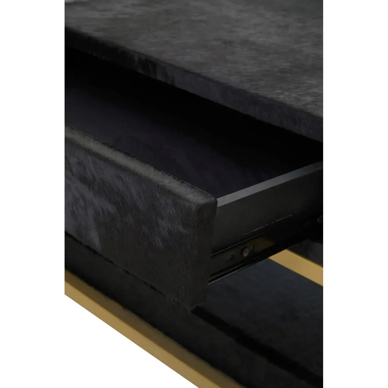 Closeup of black velvet drawer front on a modern side table with gold accent base