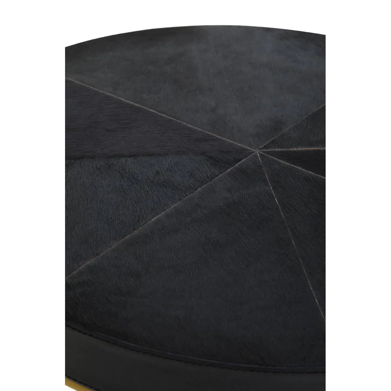 Closeup of black leather ottoman with stitched geometric panels