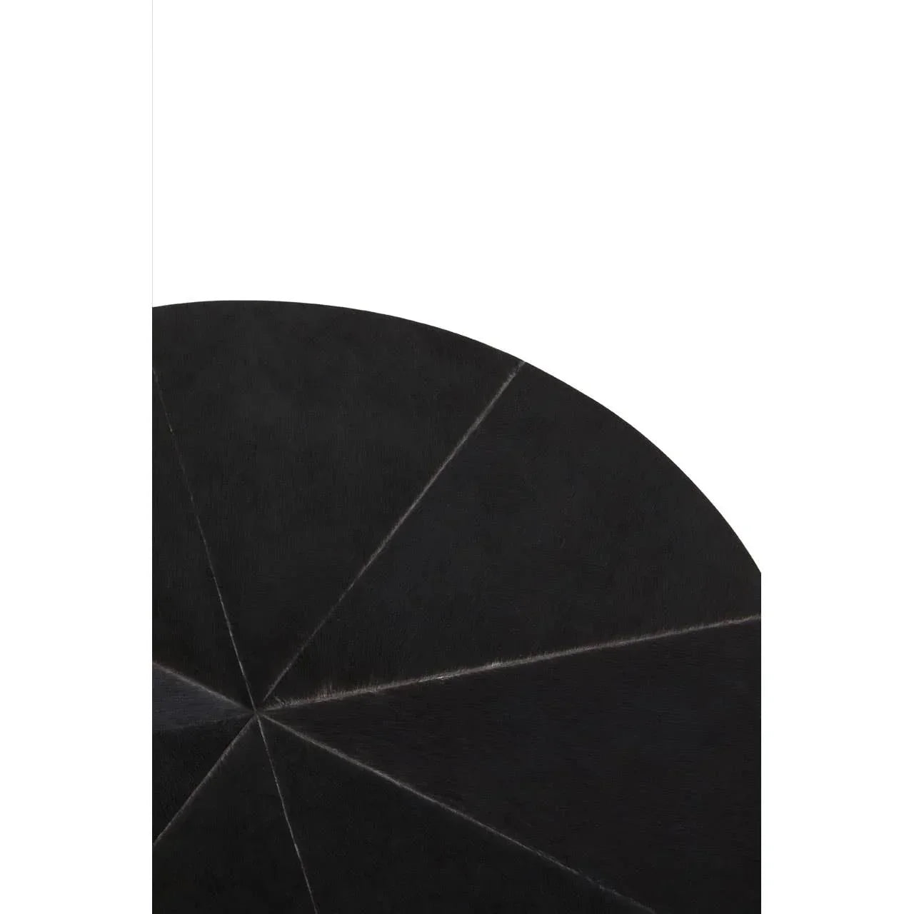 Black round coffee table top with geometric stitched leather pattern, close-up view