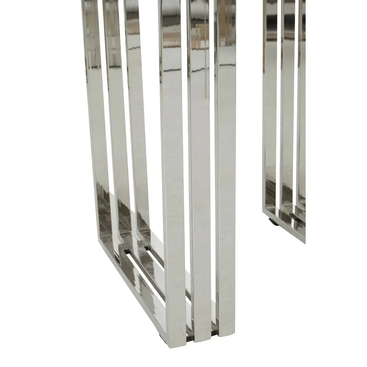 Closeup of chrome metal table legs with geometric open frame design