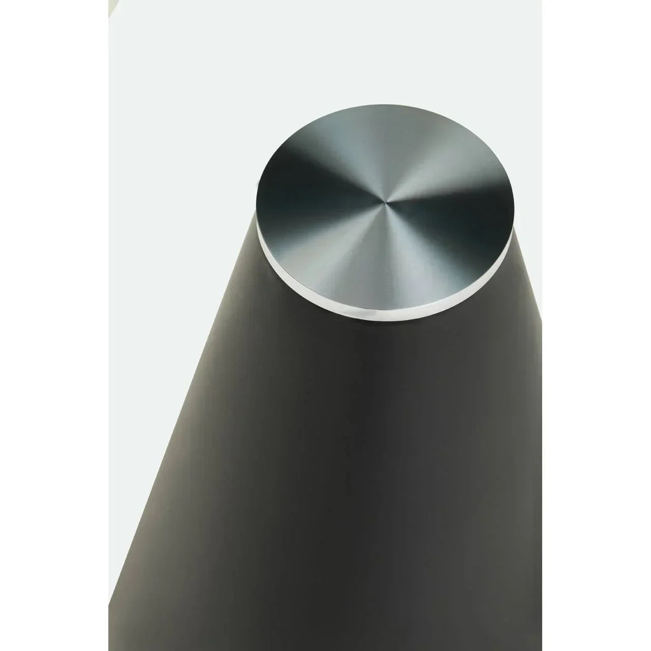Brushed metal table leg with conical black base, modern furniture detail closeup