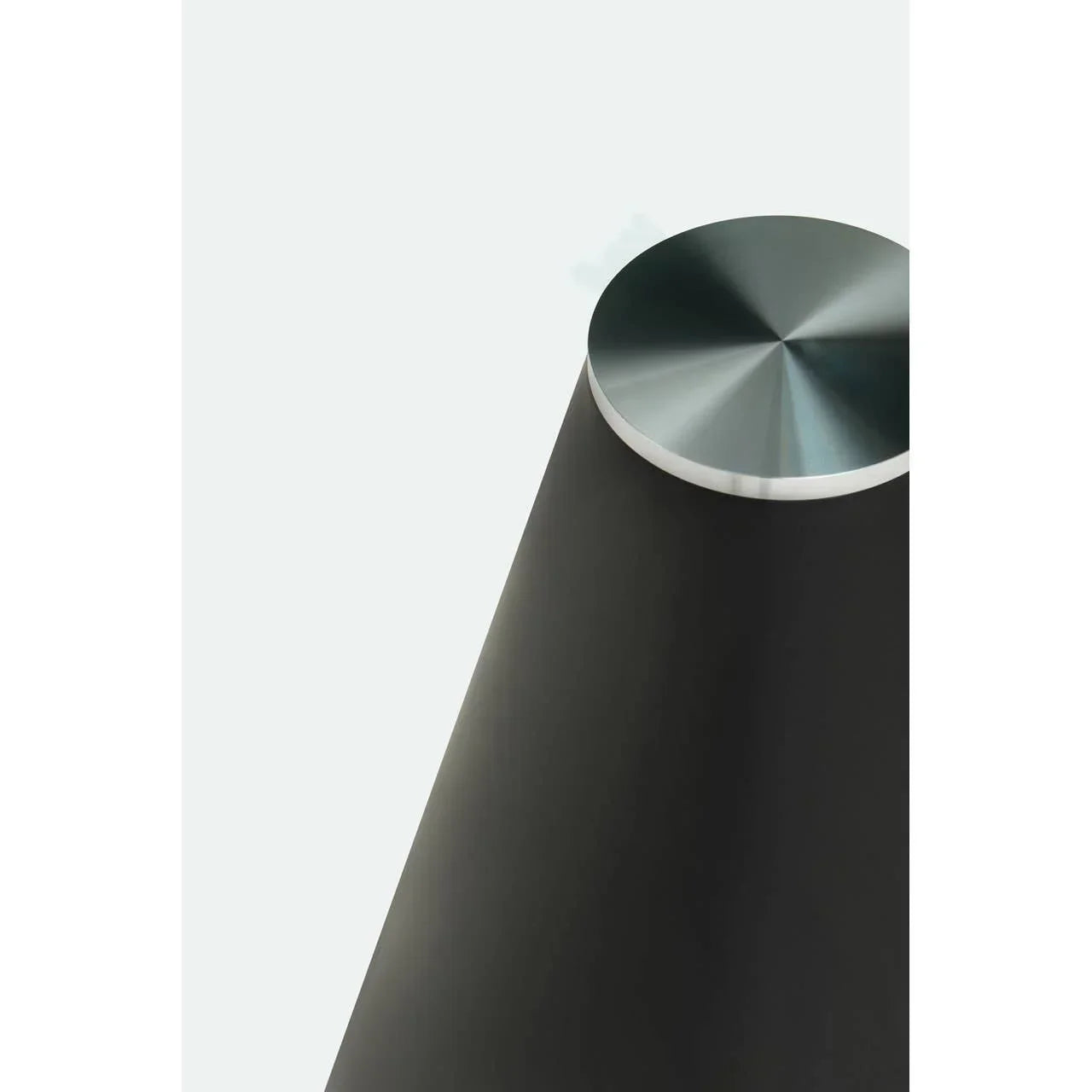 black metal dining table leg with brushed steel cap, modern furniture detail closeup
