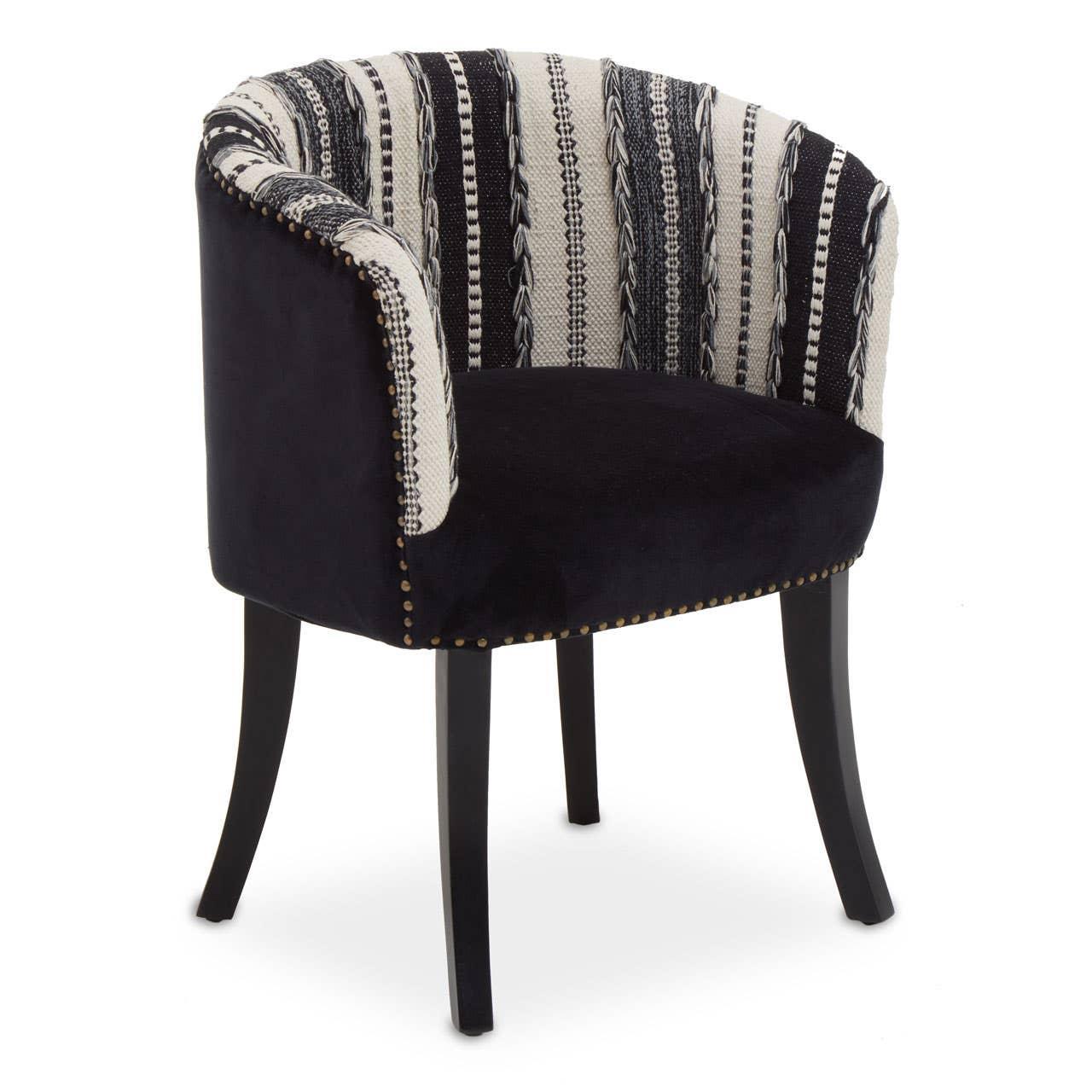 Black and white accent chair with patterned fabric upholstery and curved backrest