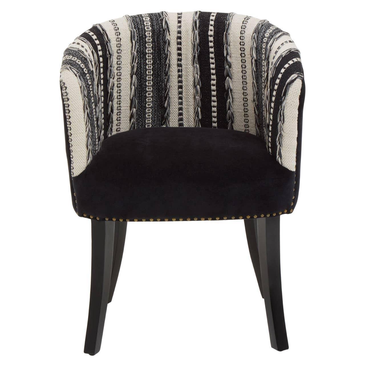 Black and white accent chair with patterned fabric and dark wooden legs, front view