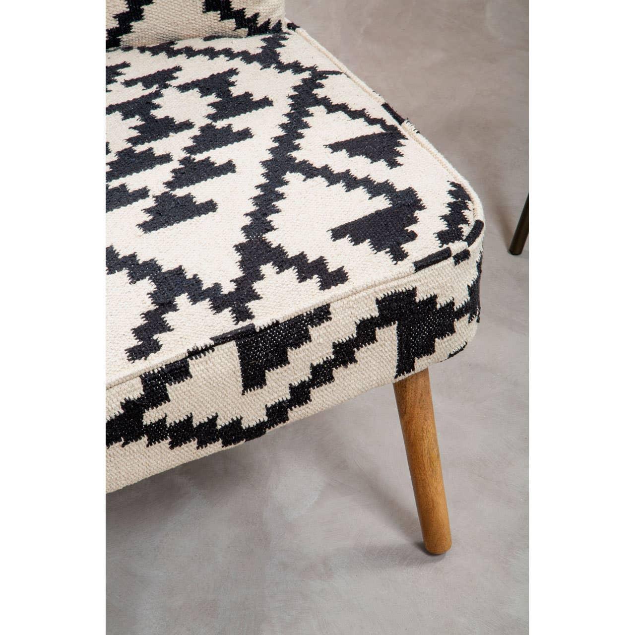 Patterned accent chair with geometric black and cream upholstery and wooden legs