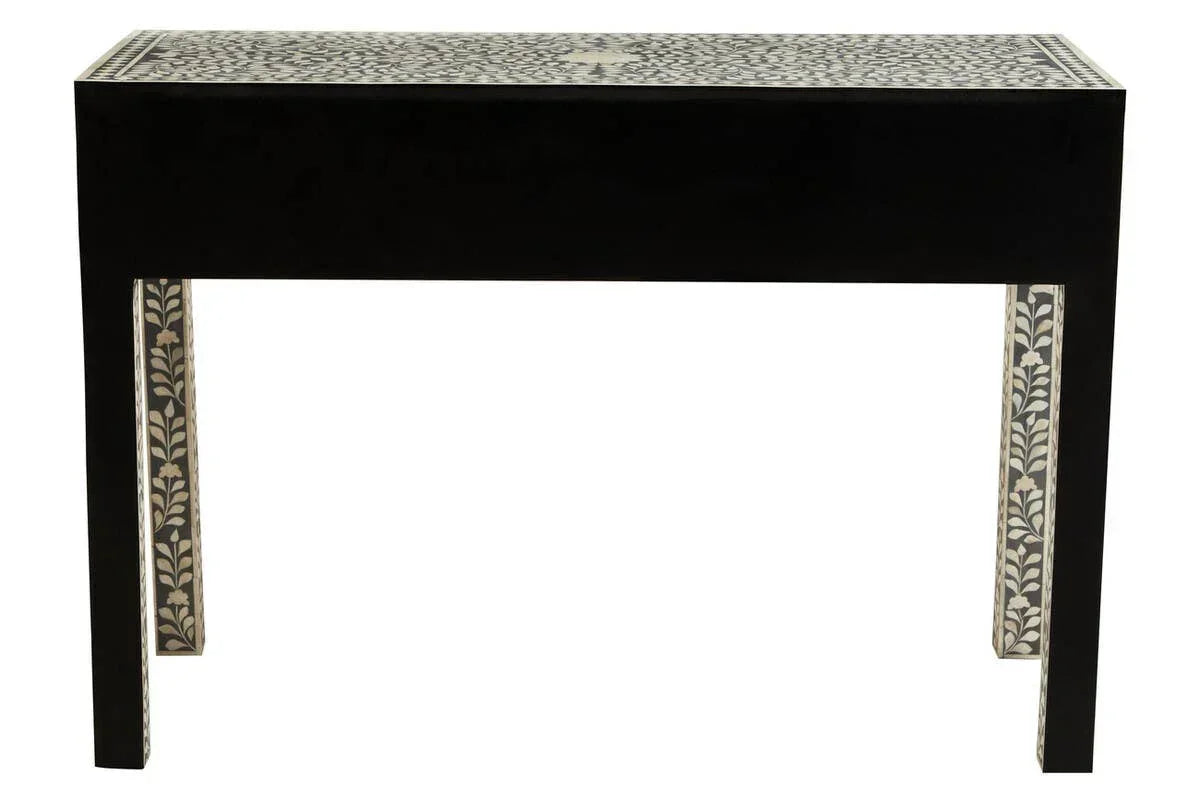Black console table with bone inlay floral pattern on top and legs