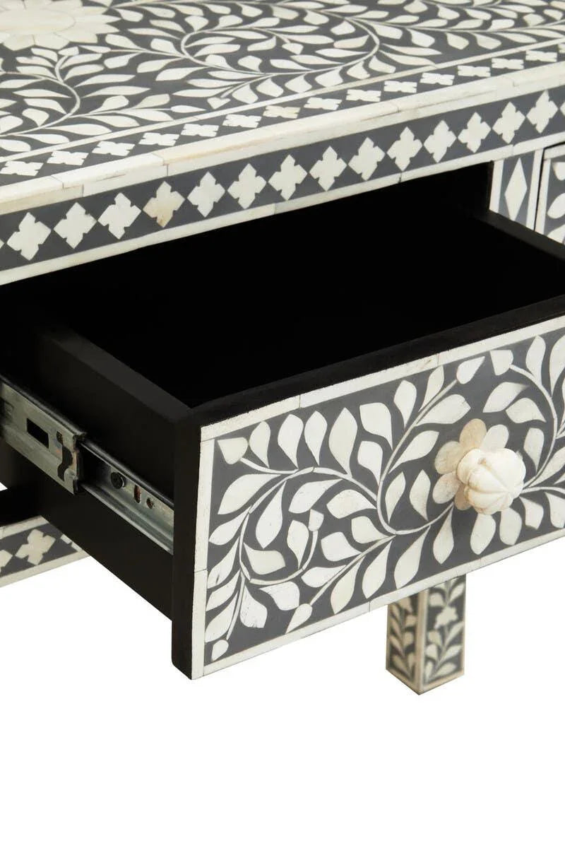 Black and white bone inlay console table with floral pattern and open drawer
