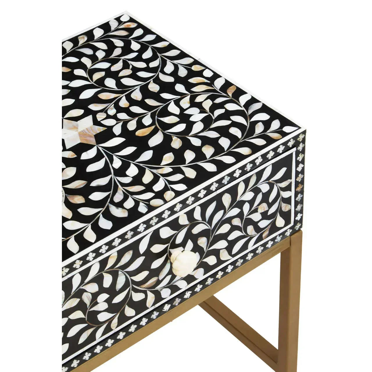 Black side table with white and beige floral inlay pattern and gold metal legs
