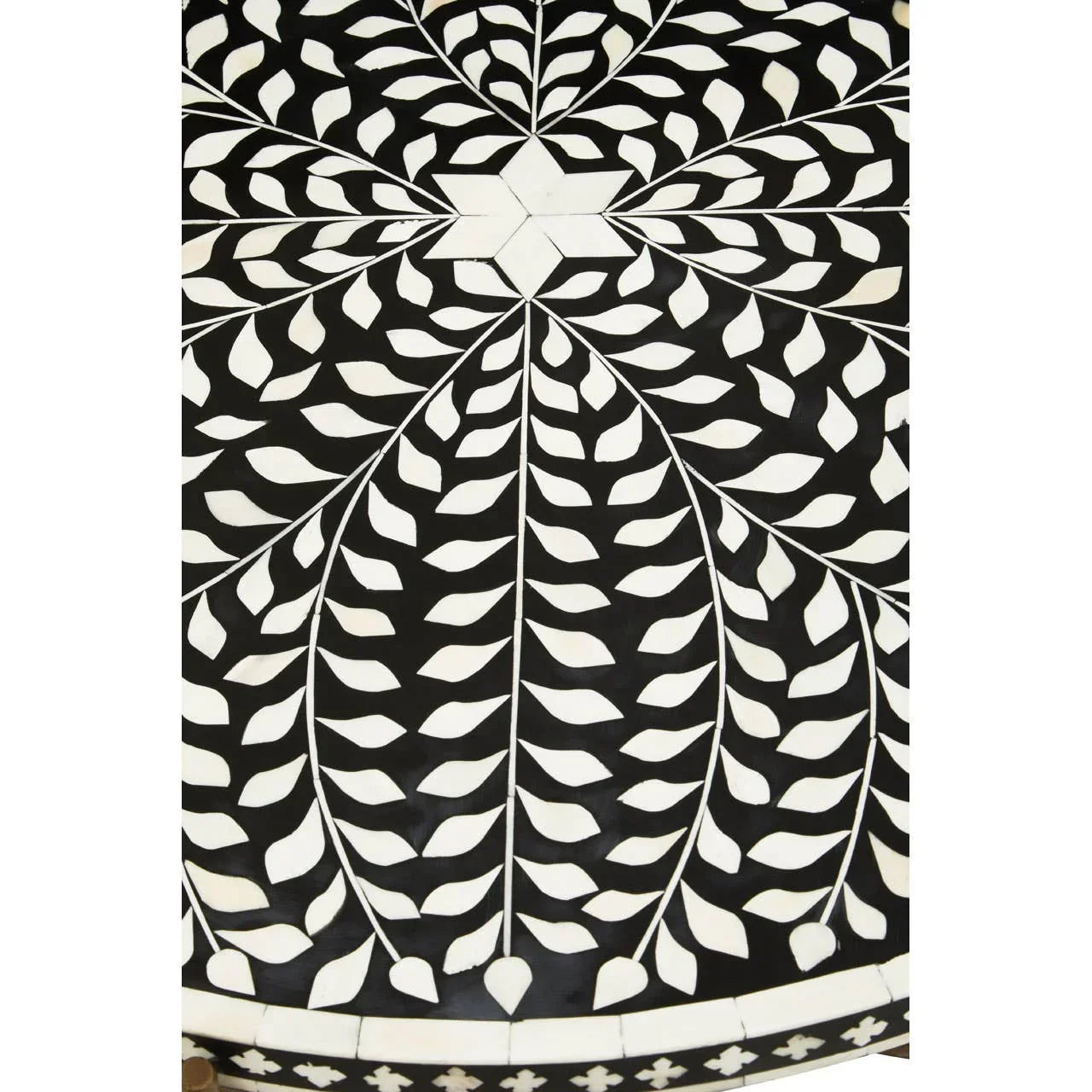 Black and white bone inlay tabletop with leaf pattern and geometric center detail