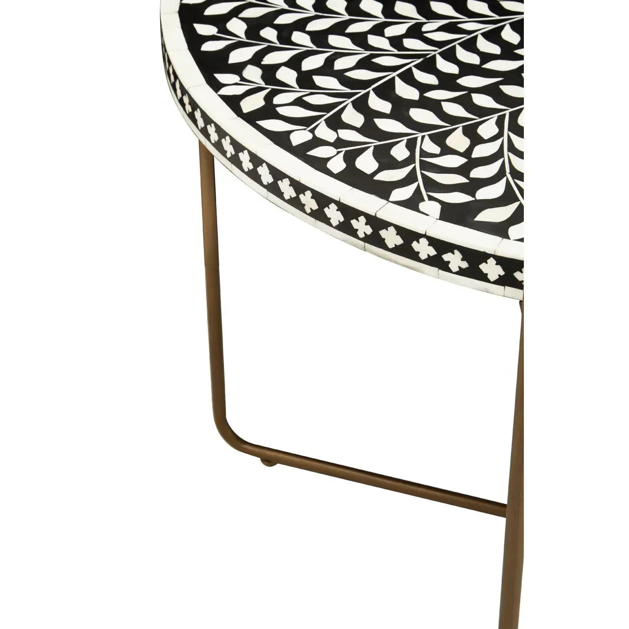 Black and white mosaic side table with leaf pattern top and slender gold metal legs