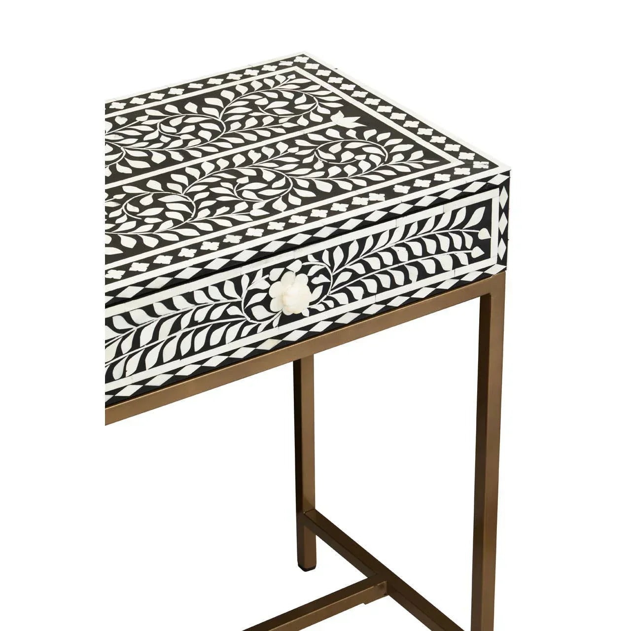 Black and white inlay side table with floral pattern and gold metal legs, front angled view