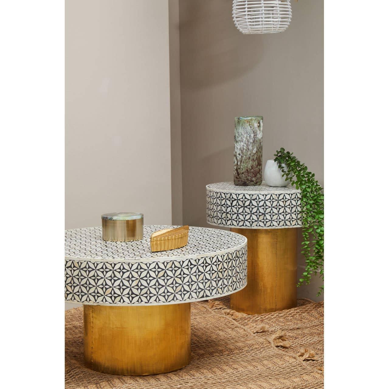 Round coffee tables with geometric mosaic tops and gold bases, styled with decorative items