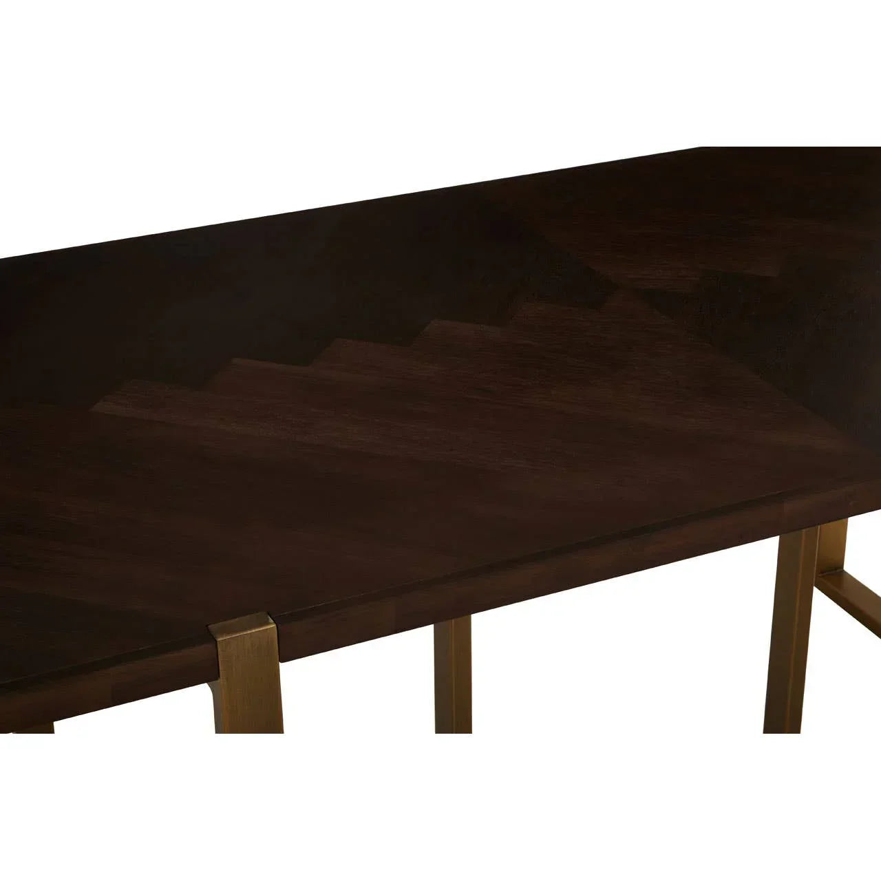 Dark wood dining table top with gold-colored metal legs, close-up view