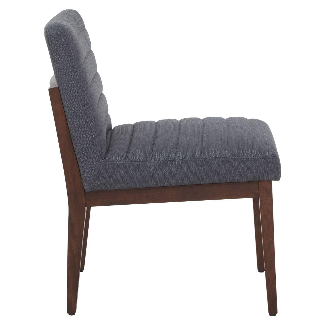 Side view of grey upholstered dining chair with wooden legs and vertical stitching
