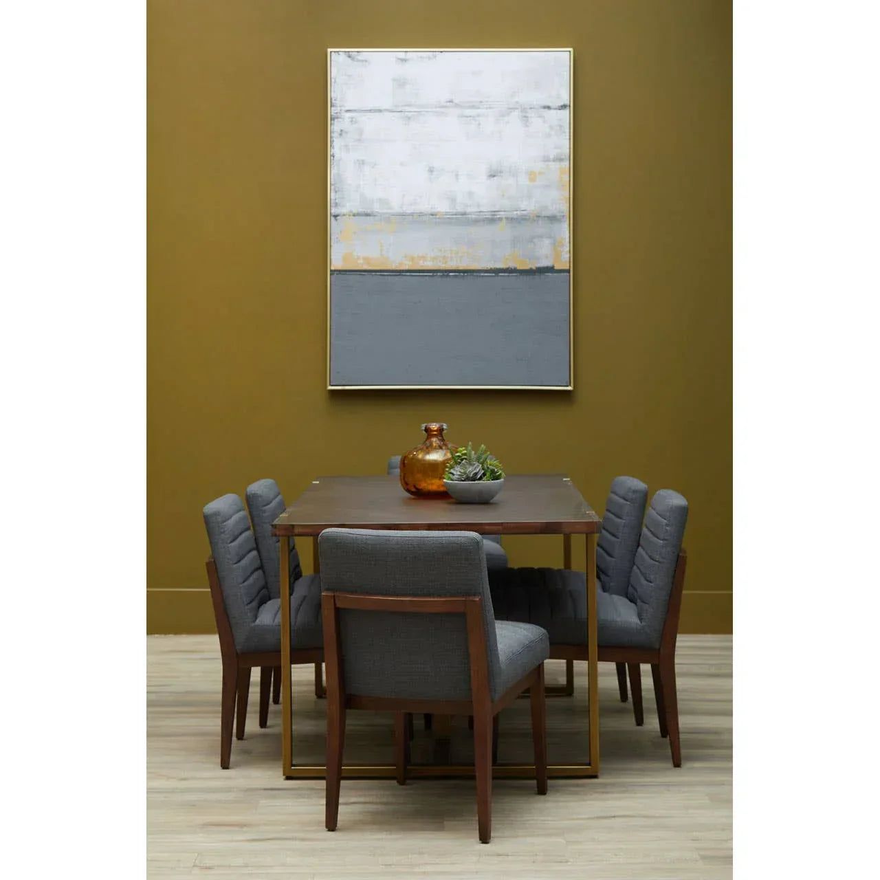 Modern dining table set with six grey upholstered chairs and wooden legs, wall art above