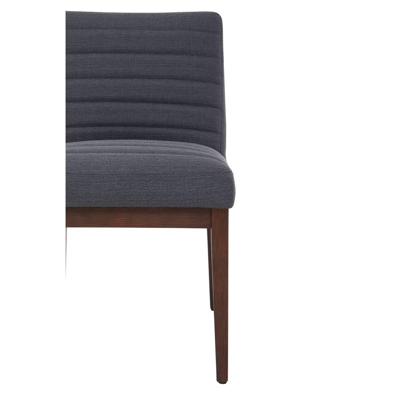Grey fabric dining chair with horizontal stitching and wooden legs, side view