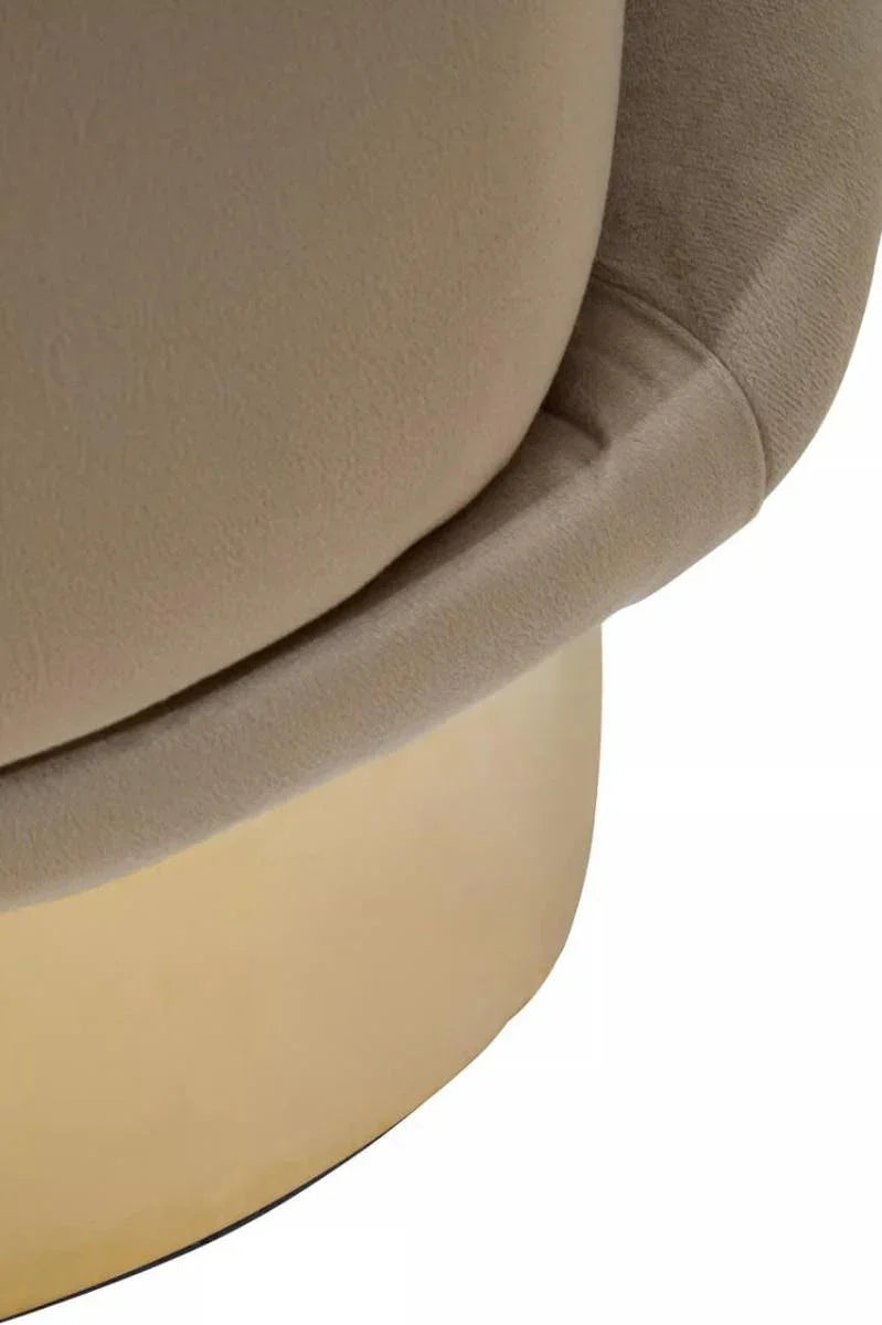 Beige velvet chair closeup with rounded cushion and gold metal base detail