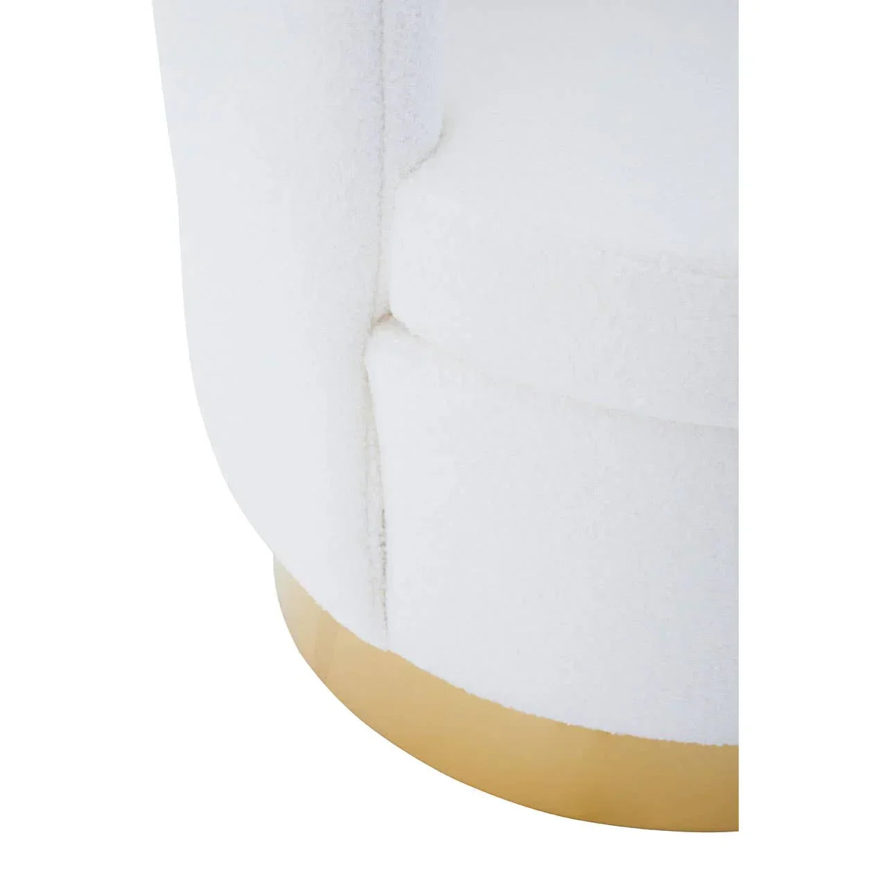 Close-up of white boucle armchair with gold base detail