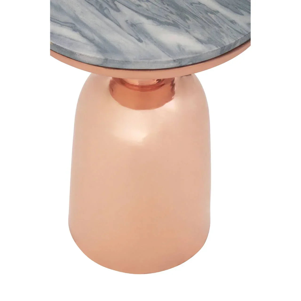 Round side table with marble top and metallic copper base, close-up view