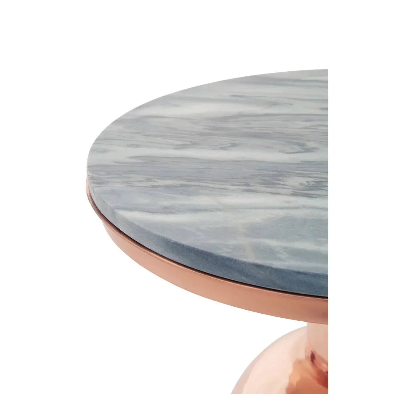 Round marble table top with copper base detail, close-up view