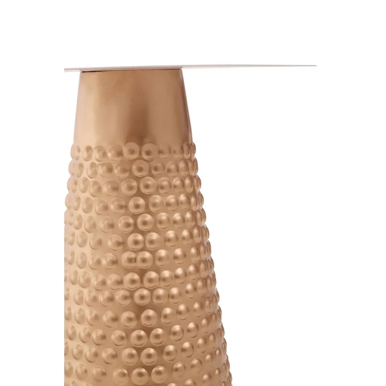 Brushed gold metal table base with textured dot pattern and smooth top edge close-up